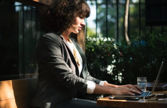 A woman working on her laptop.