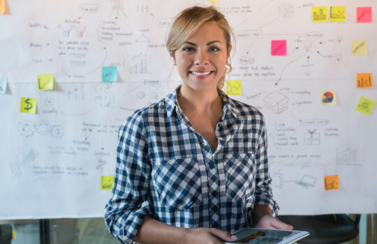 A woman stood in front of a business plan.