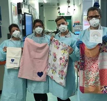 NHS staff members holding up Scrub bags made by the Brislington Womens Institute