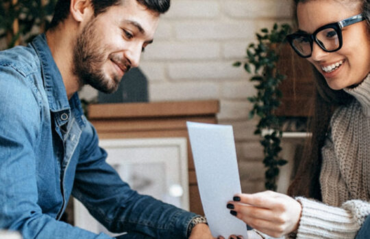 Man and woman looking at receipt