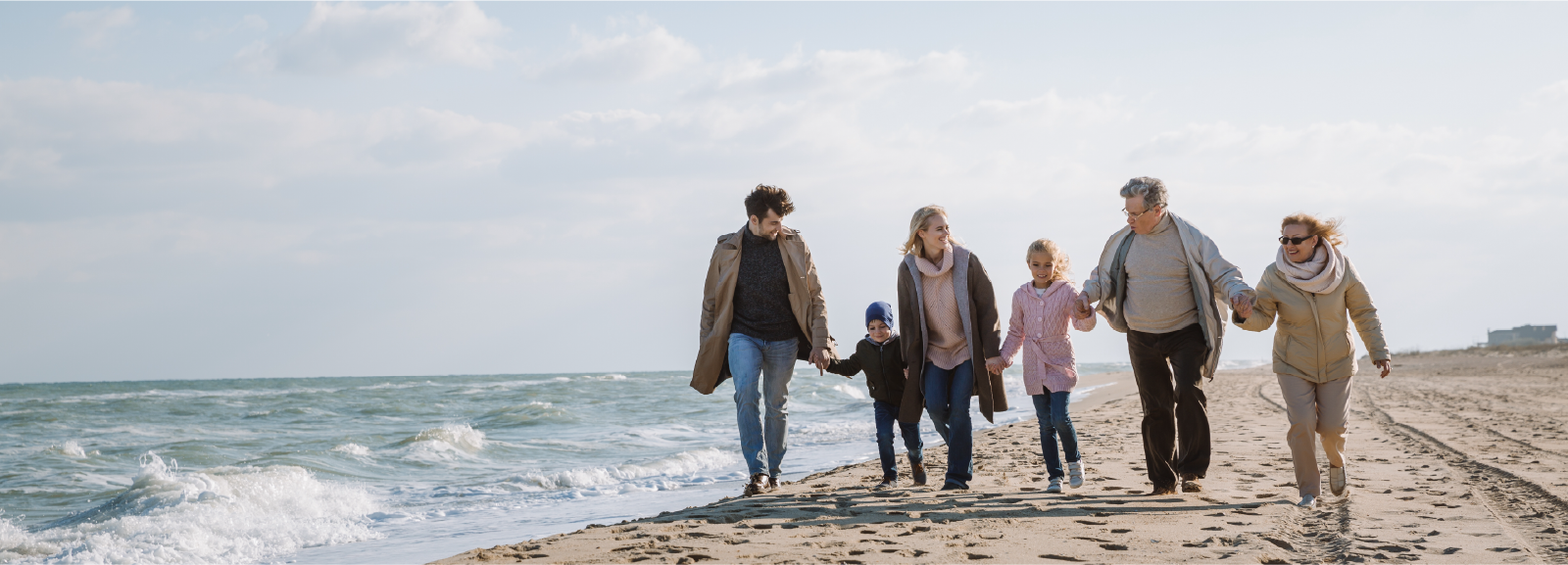 Happy family taking a walk on a beach